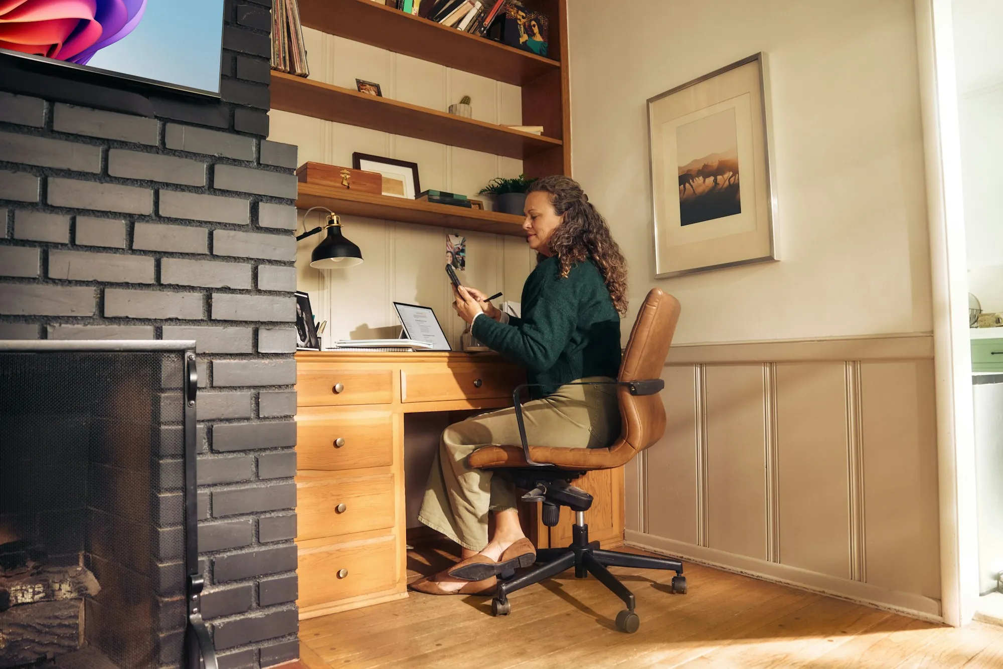 A woman working at a desk in a home office