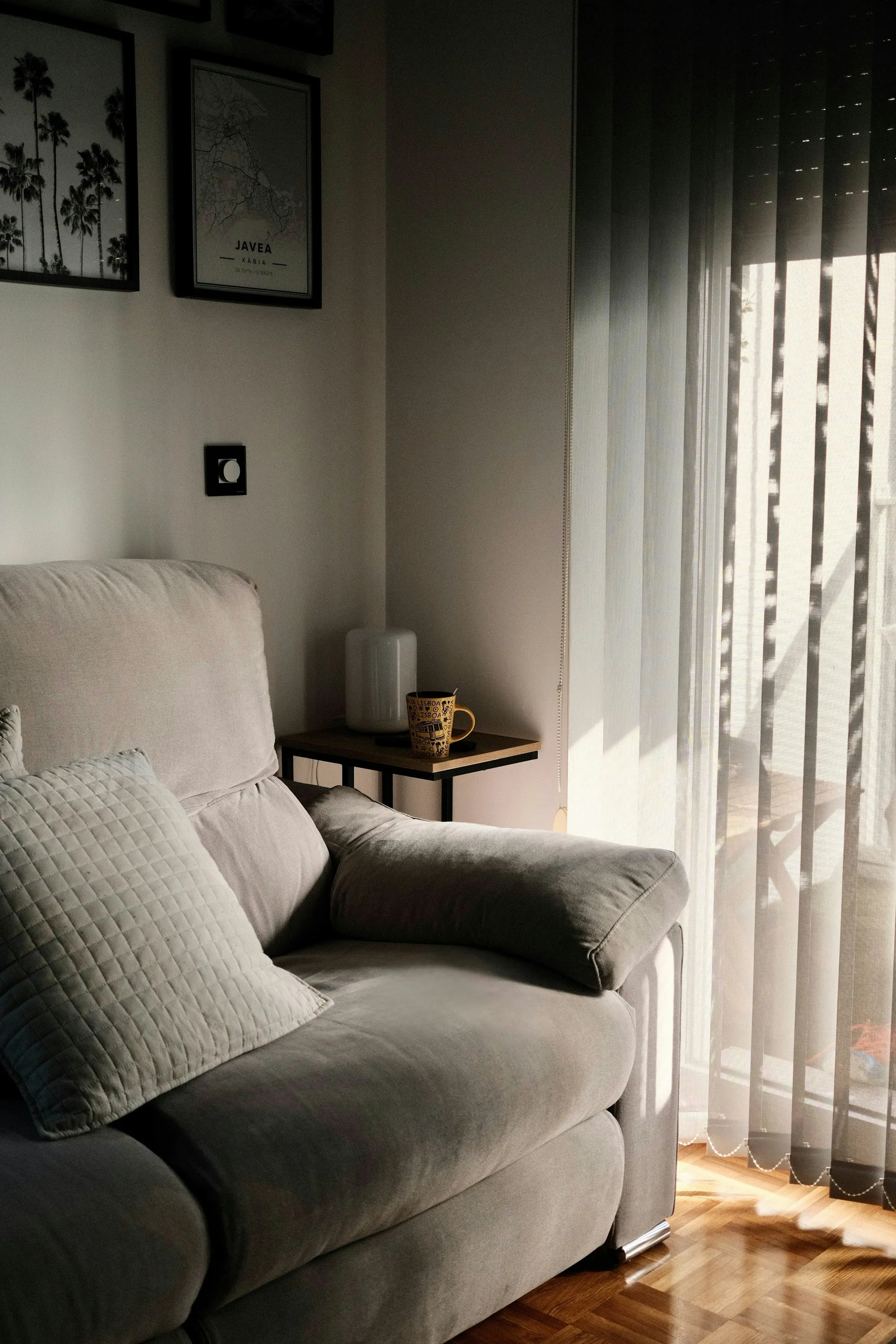 A sofa in sunlight beside a window