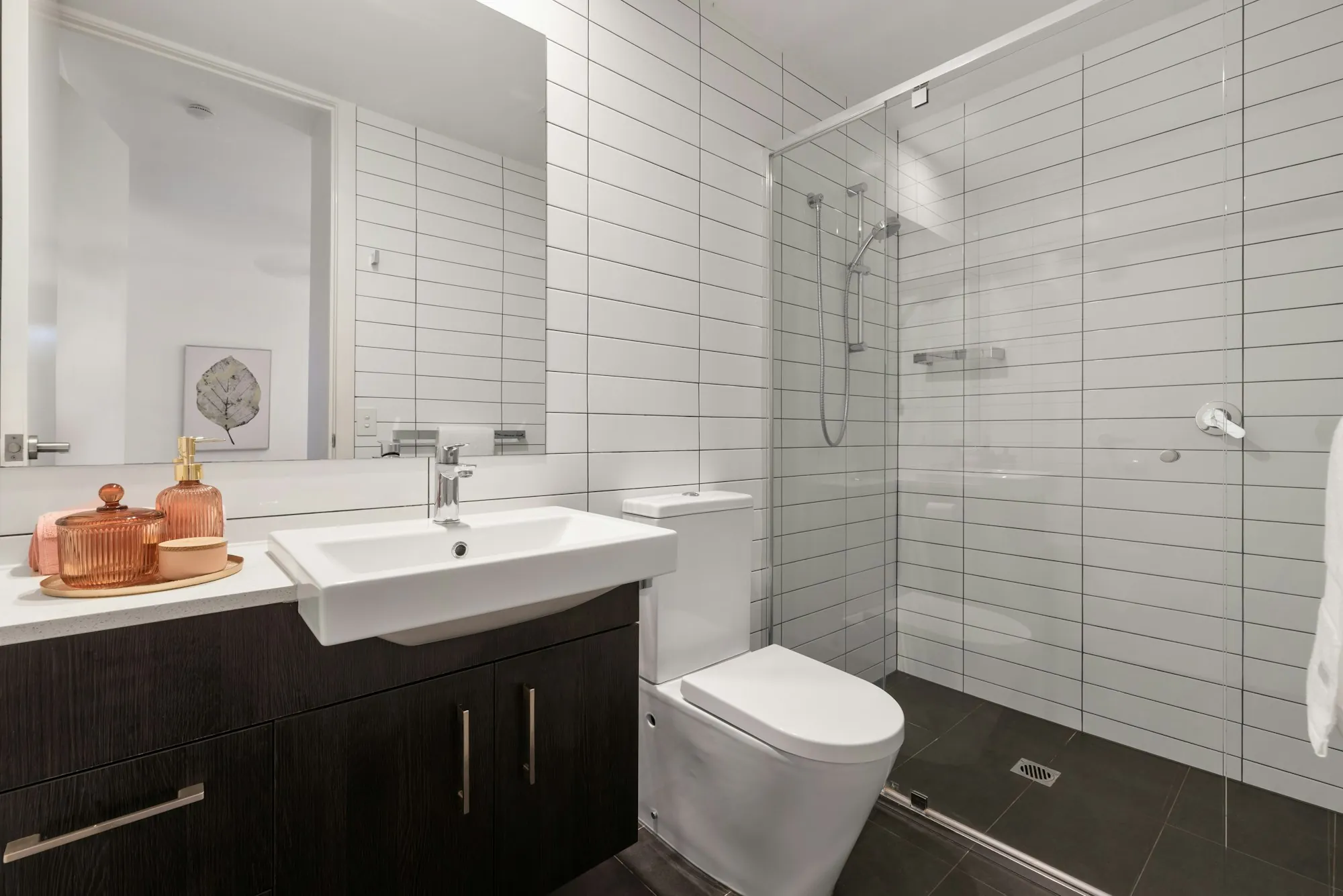 A white basin and tap in a tiled bathroom