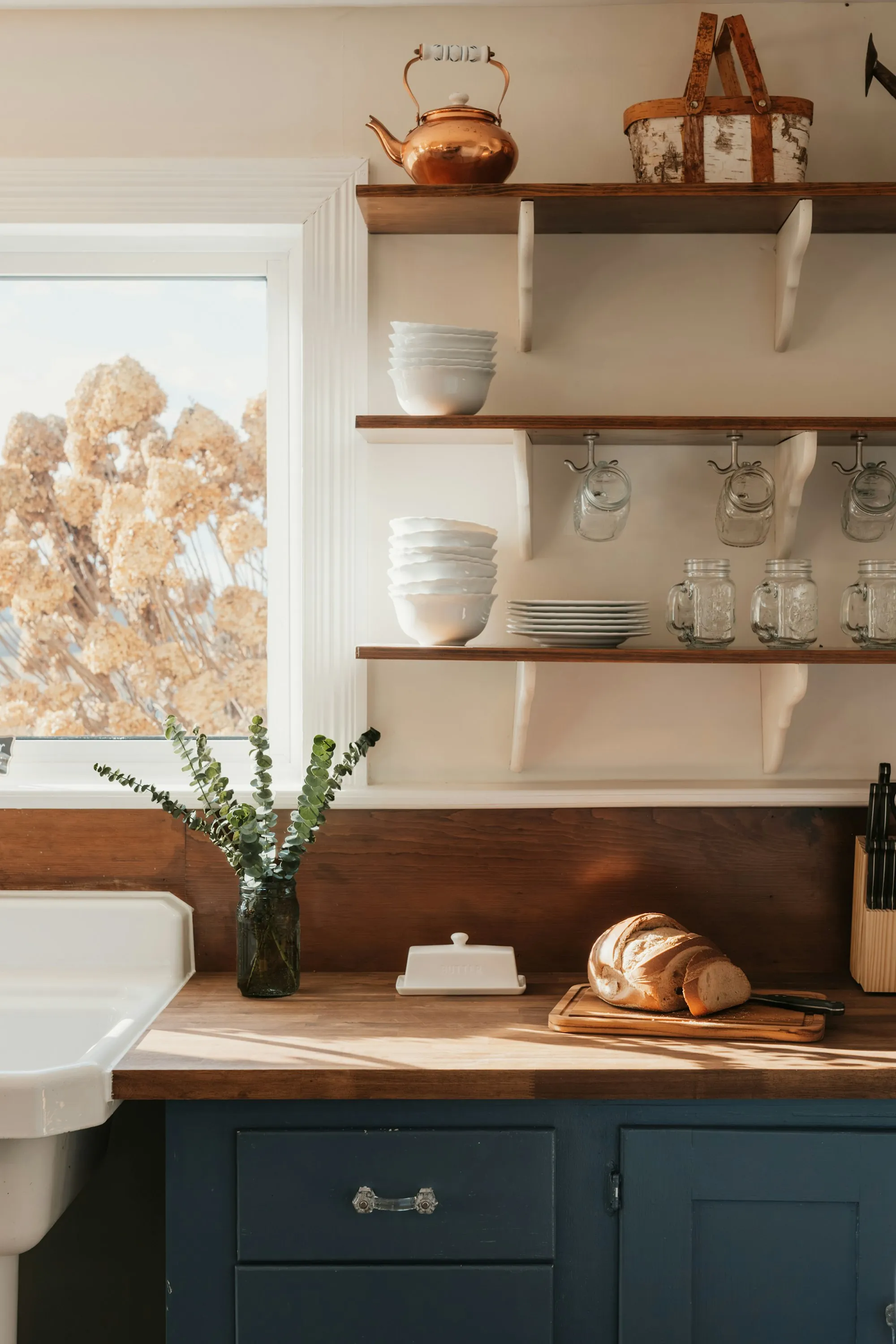 A kitchen counter with bread and clean dishes