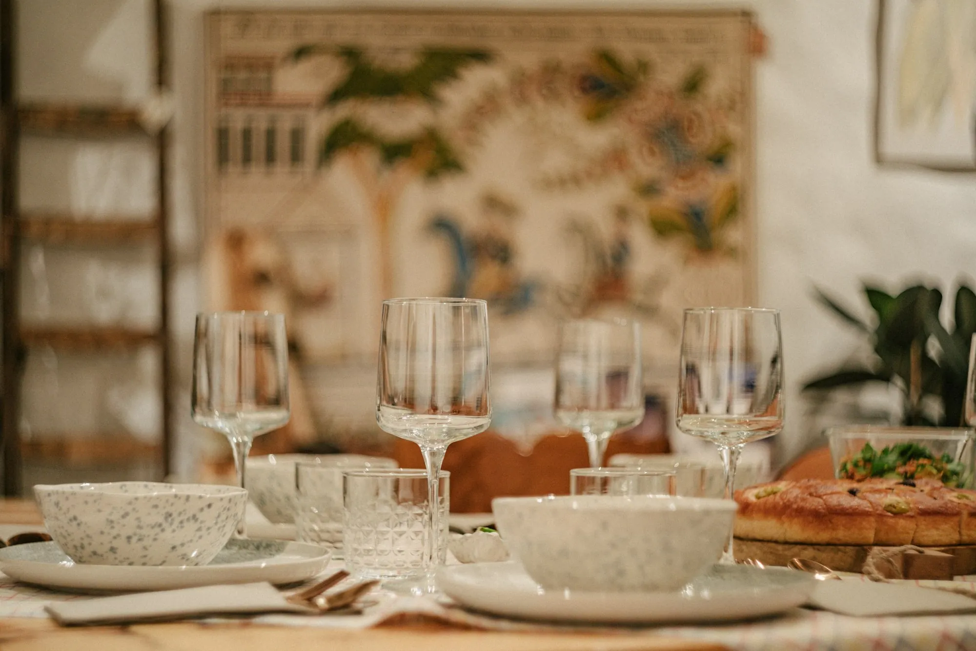 A table laid for a meal with plates and glasses